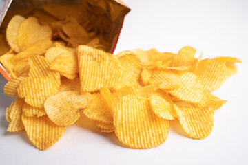 Potato chips, delicious BBQ seasoning spicy for crips, thin slice deep fried snack fast food in open bag.