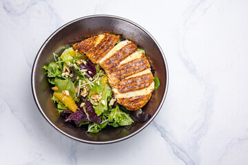 Delicious salad with chicken, orange and arugula