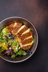 Delicious salad with chicken, orange and arugula