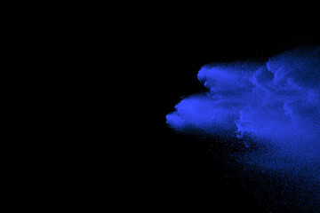 blue powder explosion on black background. Colored cloud. Color dust explode. Paint Holi
