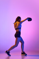 Striking image of female, professional sportsman, boxer showcasing her prowess in boxing gear against gradient studio background in neon filter. - obrazy, fototapety, plakaty
