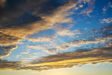Real amazing panoramic sunrise or sunset sky with gentle colorful clouds.