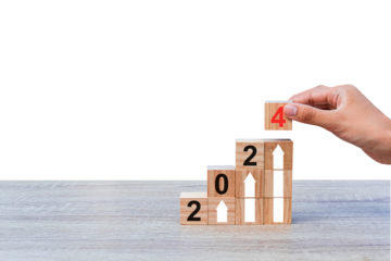 Hands putting wooden cube blocks with icons on wooden table. Start new year 2024 with goal plan, goal concept, action plan, strategy, new year business vision. PNG