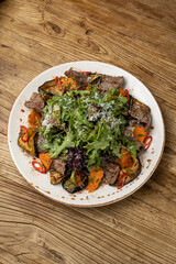 Delicious salad with meat, eggplant and pumpkin