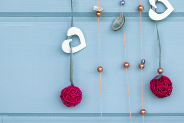 Handmade Christmas decoration hangs on a blue wall