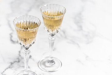champagne in glasses on a marble table close-up, Valentine's Day, holiday.	