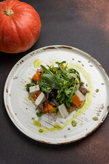 Delicious salad with feta cheese, arugula and pumpkin