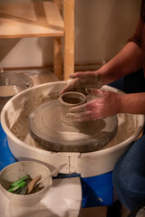 Potters wheel with hands forming clay to art