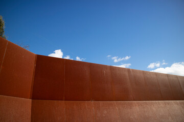Photographic documentation of an iron wall thrown into the blue sky