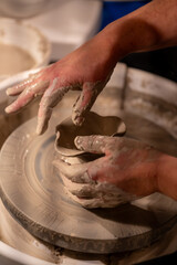 Potters wheel with hands forming clay to art