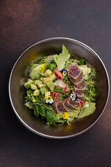 Delicious salad with tuna, avocado and arugula
