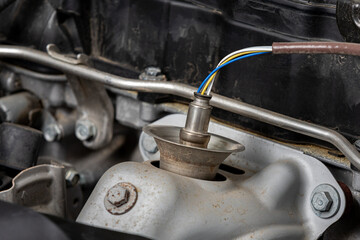 Oxygen sensor on car engine. Automotive repair, maintenance and service.