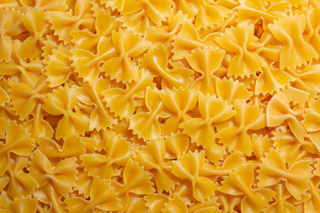 Uncooked Farfalle Pasta: A Culinary Canvas of Bow-Tie Macaroni, Creating a Lively and Textured...
