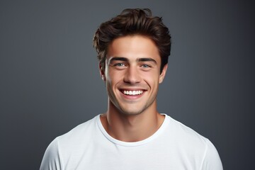 Fototapeta na wymiar Young man with beautiful smile on grey background. Teeth whitening