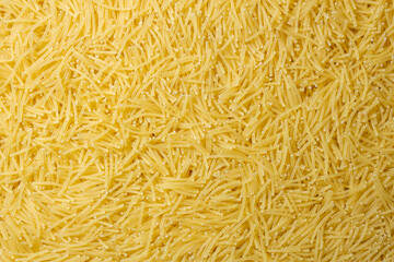 Uncooked Filini Pasta: A Culinary Canvas of Noodles, Creating a Lively and Textured Background for Gourmet Cooking. Dry Pasta. Raw Macaroni - Top View, Flat Lay