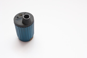 A blue pencil sharpener sits on a white background. - Powered by Adobe