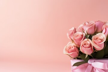 postcard. pink roses with a ribbon on a pink background. place for the text