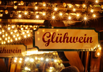 Mulled wine stand at the Christmas market in the evening with lighting