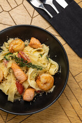 Delicious pasta with shrimp, tomatoes and salmon