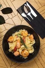 Delicious pasta with shrimp, tomatoes and salmon