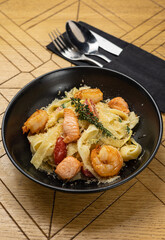 Delicious pasta with shrimp, tomatoes and salmon