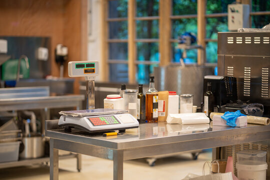 Modern professional kitchen in confectionery industry for preparing cooking desserts, food. Well equipped culinary room workshop for sweets, bakery production. Metal furniture scales products to cook.