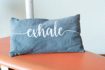 small pillow that says exhale placed on gyrotonic training bed
