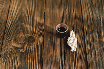 Communion. Religious tradition of breaking bread. Bread and wine as a sign of memory of Christ's sacrifice.