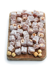 Turkish delight with phistachio and almond covered with coconut isolated on white