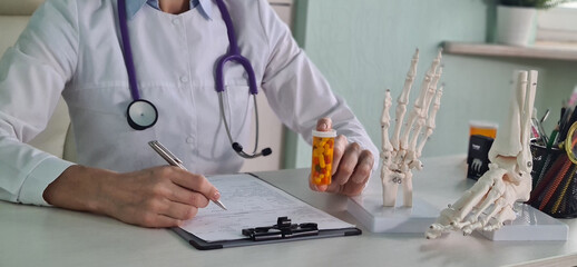 Pills in the hands of doctor traumatologist therapist and pain in joints