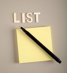 Empty note sticky paper with pen and word list