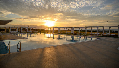 swimming pool in a residential complex on the seashore in sunset light 1