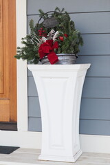 The Christmas decorations in the white vase.