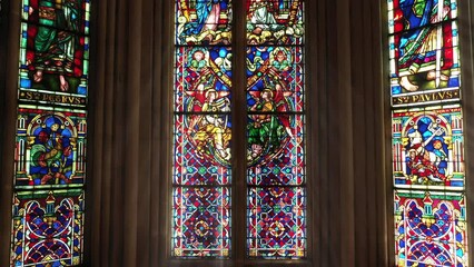 Historic stained glass with saintly inscriptions. - Powered by Adobe