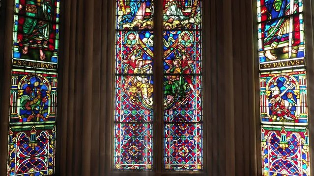 Historic stained glass with saintly inscriptions.
