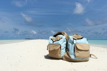 Travel vacation on tropical Island - Backpacks on a Tropical Sandbank Oasis Concept Travel Template