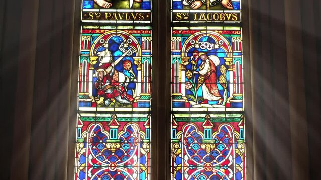 Angels in vibrant robes within ornate window design.