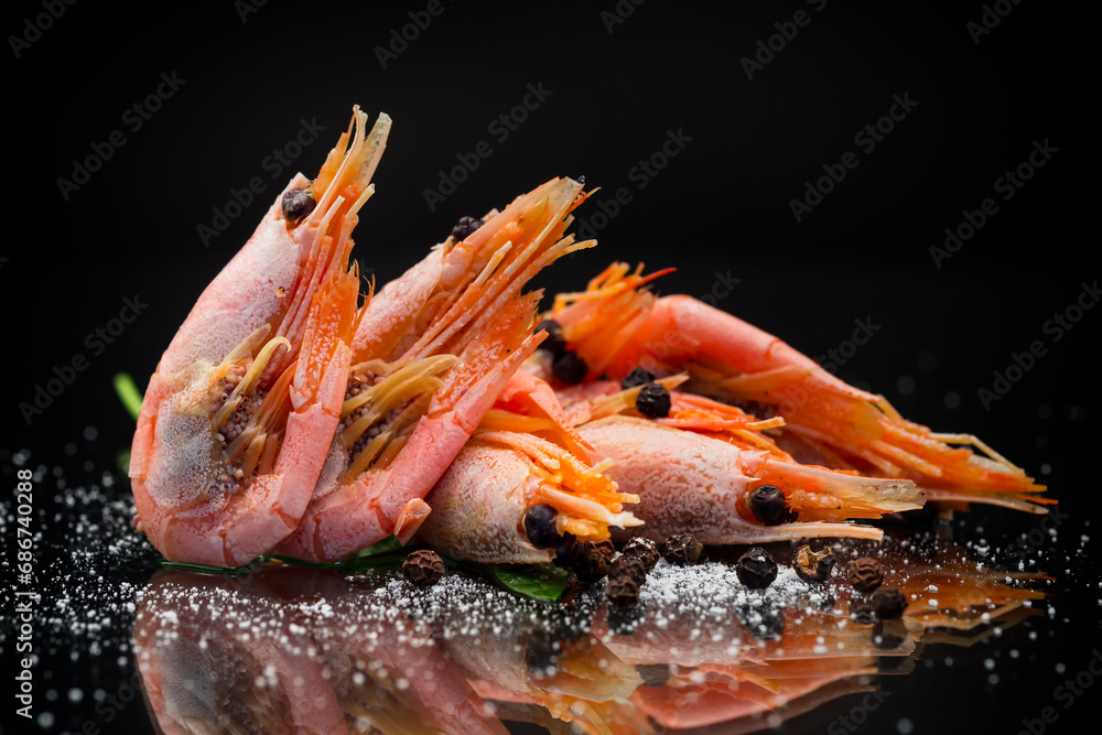 Wall mural boiled shrimp with spices on black background