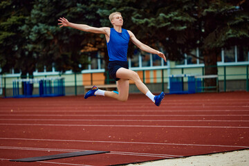 Form and function harmonize in the airborne elegance of a long jump. Athletic man, professional sportsman sets new long jump record.