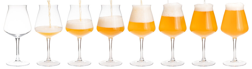 Pouring ale in tulip craft beer glass isolated on white
