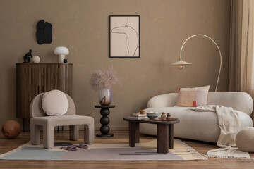 Aesthetic composition of cozy living room interior with mock up poster frame, gray armchair, wooden sideboard, round stand, lamp, stylish rug and personal accessories. Home decor. Template.