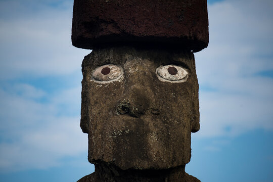 Close-up of a Moai against a blue sky with cloud at Rapa Nui National Park on Easter Island; Easter Island