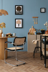 Warm and cozy dining room and kitchen interior with mock up poster frame, round table, rattan...