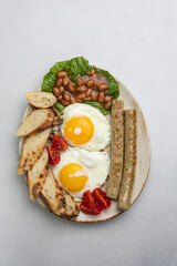 English breakfast - eggs, sausages, beans and tomatoes