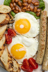 English breakfast - eggs, sausages, beans and tomatoes