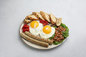 English breakfast - eggs, sausages, beans and tomatoes