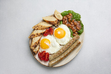 English breakfast - eggs, sausages, beans and tomatoes