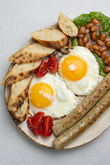 English breakfast - eggs, sausages, beans and tomatoes