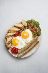 English breakfast - eggs, sausages, beans and tomatoes