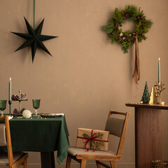 Christmas dining room interior with table, green tablecloth, wooden console, christmas wreath,...